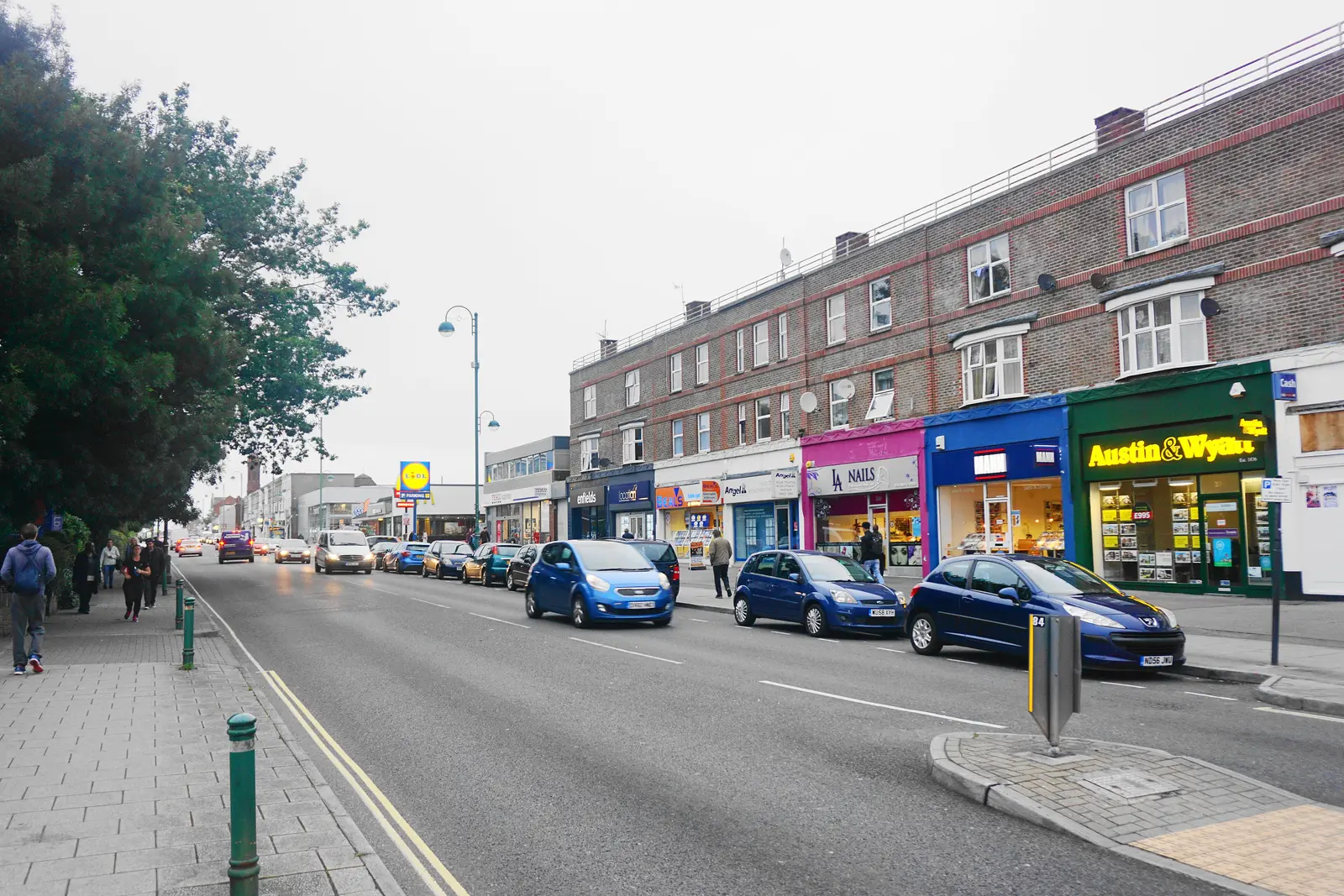 Shoppers passing the parade of shops on Shirley Road, Southampton