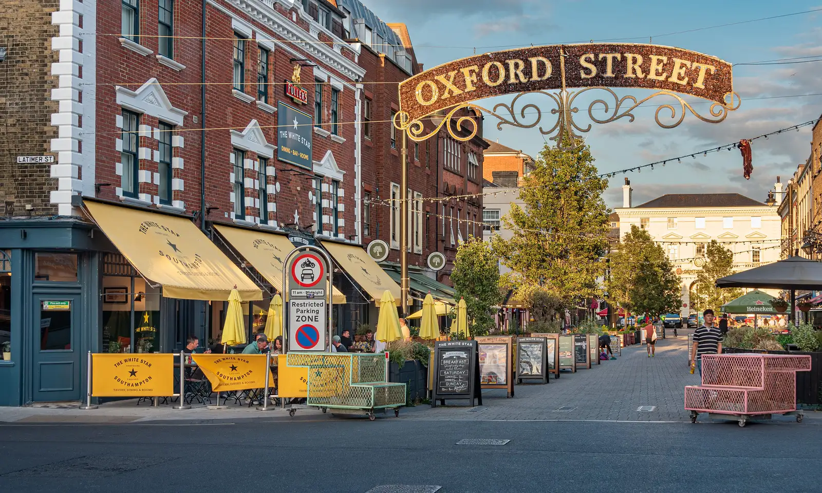 Outdoor tables outside pubs and restaurants on Oxford Street, Southampton