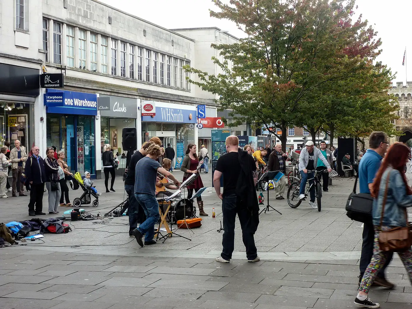 Shoppers gathering around street musicians in the Above Bar precinct, Southampton