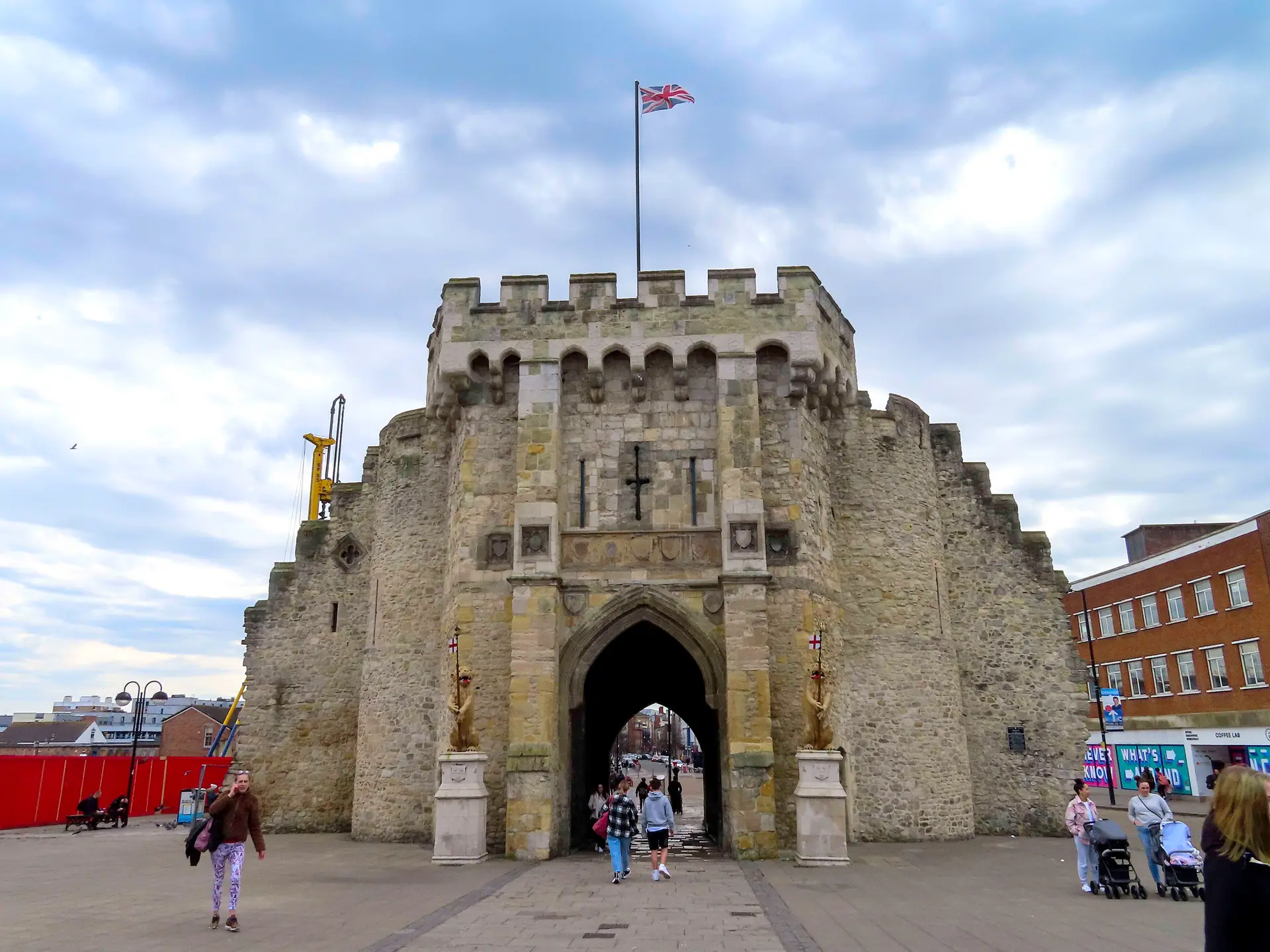 People walking through the medieval Bargate in Southampton city centre